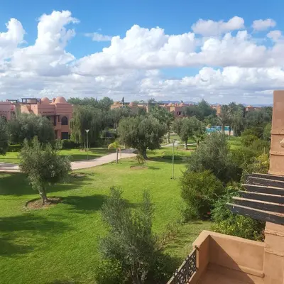 a view of a park with trees and buildings at Atlas golf rossort in Marrakech