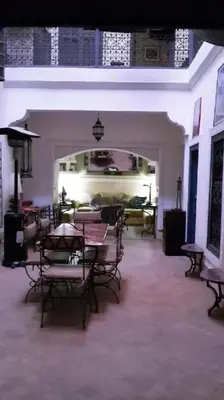 a dining room with tables and chairs in a room at Dar Nassima in Marrakech