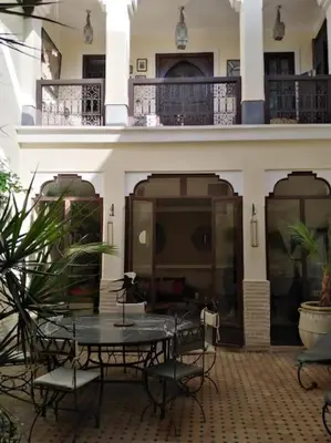 a patio with a table and chairs in a building at Dar Nassima in Marrakech