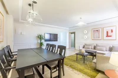 a dining room and living room with a table and chairs at ZARI Boutique ApartHotel in Marrakech