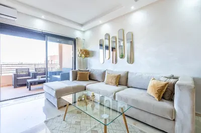 a living room with a couch and a glass table at New! Superbe appartement à Majorelle,terrace,IPTV. in Marrakech