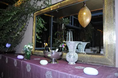 a purple table with a mirror and a vase at Riad Wow in Marrakech