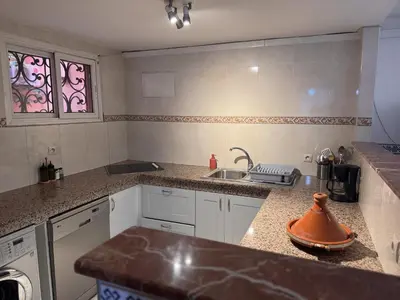 a kitchen with a sink and a counter top at Riad Naïel 3 piscines in Marrakech