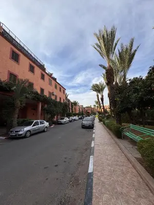 a street with cars parked on the side of the road at Riad Naïel 3 piscines in Marrakech