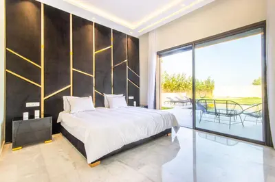 a bedroom with a large bed and a balcony at Villa California, sans vis à vis, piscine Chauffée, Spa, in Marrakech