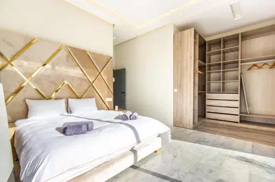 a bedroom with a large white bed and a closet at Villa California, sans vis à vis, piscine Chauffée, Spa, in Marrakech