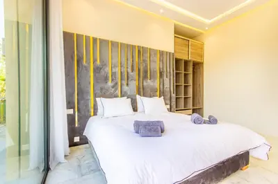 a bedroom with a large white bed and a window at Villa California, sans vis à vis, piscine Chauffée, Spa, in Marrakech