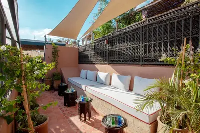 a patio with a white couch on a balcony at Riad JW, La Medina autrement in Marrakech