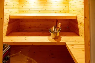 a wooden sauna with a bucket in the middle at Riad SofYan & Spa in Marrakech
