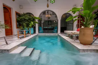 a swimming pool with blue water in a house at Riad SofYan & Spa in Marrakech