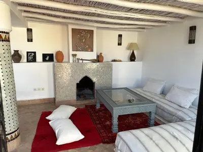 a living room with a couch and a fireplace at Riad Hugo in Marrakech