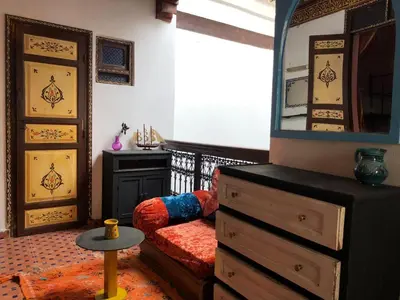 a living room with a dresser and a mirror at Hostel Kech Vibe in Marrakech