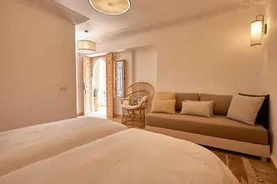 a bedroom with a bed and a couch at Ryad Selyen in Marrakech