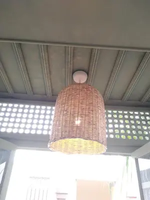a wicker chandelier hanging from a ceiling at Riad Lalla Mimouna in Marrakech