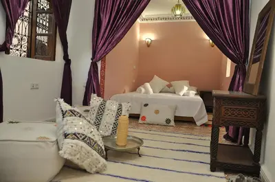 a living room with two beds and a couch at Dar Aouinti in Marrakech