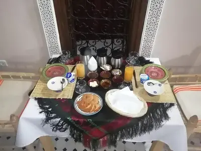 a table with food and drinks on it at Dar Aouinti in Marrakech