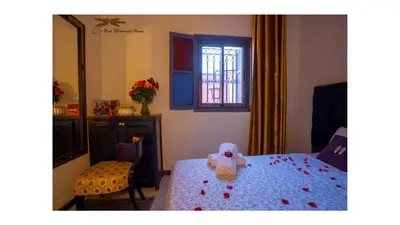 a bedroom with a bed with a stuffed animal on it at Winarouze house in Marrakech