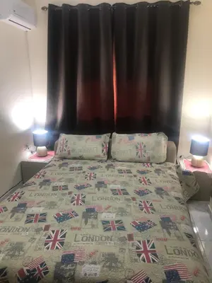 a bedroom with a bed with a black curtain at Appartement cosy et discret in Marrakech