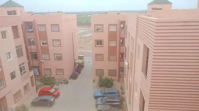 an aerial view of a parking lot in front of buildings at Appartement cosy et discret in Marrakech