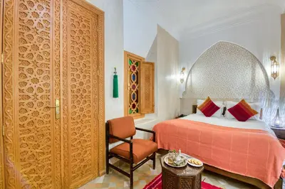 a hotel room with a bed and a chair at Palais Tara & Spa in Marrakech