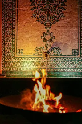 a fire in a fireplace with a wall in the background at Villa Taj Sofia & Spa in Marrakech