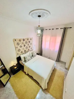 a bedroom with a white bed and a window at Terrasse Majorelle & Mogador in Marrakech