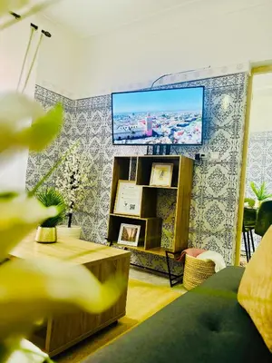 a living room with a flat screen tv on a wall at Terrasse Majorelle & Mogador in Marrakech
