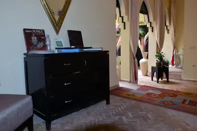 a bedroom with a dresser and a hallway at Riad Dar La Rose in Marrakech