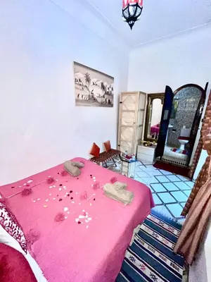 a room with a pink table with food on it at RIAD TENDANCE IN MARRAKECH in Marrakech