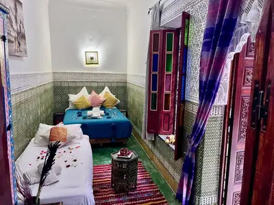 a room with two beds in a room at RIAD TENDANCE IN MARRAKECH in Marrakech