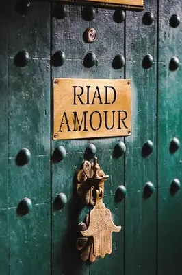 a metal door with a sign that reads raid armour at Riad Amour in Marrakech