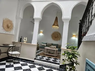 a living room with a couch and a checkered floor at Duplex el Madina in Marrakech
