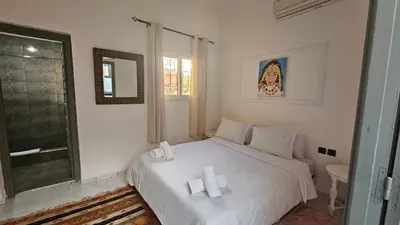 a bedroom with a white bed with two towels on it at Duplex el Madina in Marrakech