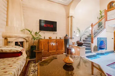 a living room with a bed and a fireplace at Riad Cozy Marrakech, Shared Pool with 3 Rooms in Marrakech