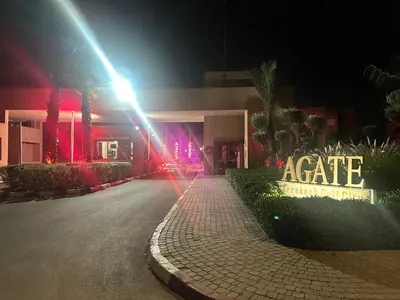 a building with a sign that reads acate at night at Appartement de luxe prestigia Golf Resort in Marrakech