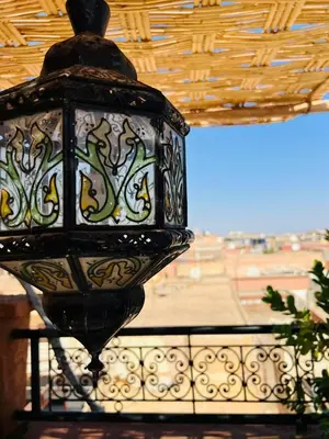 a close up of a lantern hanging from a ceiling at Riad MS holidays terrasse privatisé Marrakech in Marrakech