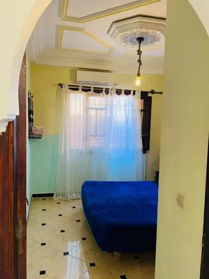 a blue bed in a room with a window at Riad MS holidays terrasse privatisé Marrakech in Marrakech