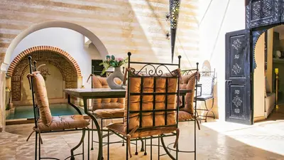 a dining room with a table and chairs at Riad RIM in Marrakech