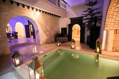 an indoor swimming pool with lights in a house at Riad RIM in Marrakech