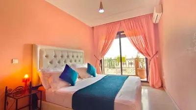 a bedroom with a large bed and a window at Résidence Anas Majorelle -Centre Ville in Marrakech