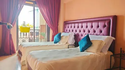 a hotel room with two beds and a window at Résidence Anas Majorelle -Centre Ville in Marrakech