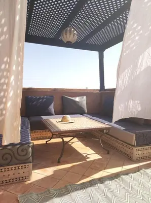 a patio with a couch and a table at Appart atlas resort in Marrakech