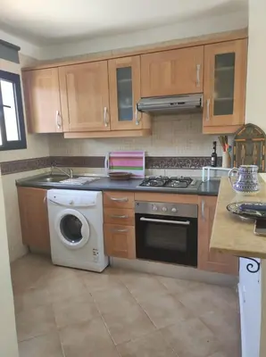 a kitchen with a stove and a washing machine at Appart atlas resort in Marrakech