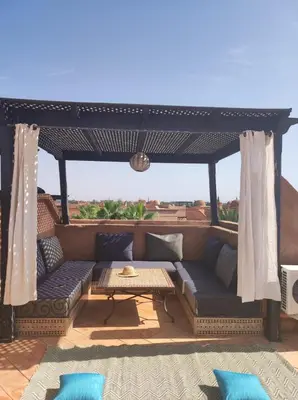 a patio with a couch and a table at Appart atlas resort in Marrakech