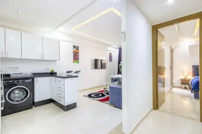 a kitchen with a washing machine in a room at NEW! Plein Gueliz, terrasse, wifi in Marrakech