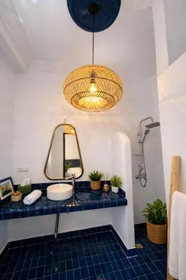 a bathroom with a sink and a mirror at RIAD JOUJ- Oasis privée avec bassin et SPA - kasbah in Marrakech