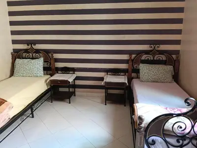 two beds in a room with black and white stripes at Au centre,Charmant appartement dans un quartier chic et calme, Très bon emplacement in Marrakech