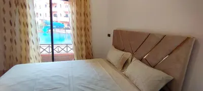 a bedroom with a bed and a window with a view at Palmera de Marrakech in Marrakech