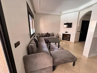 a living room with a couch and a fireplace at Palmera de Marrakech in Marrakech