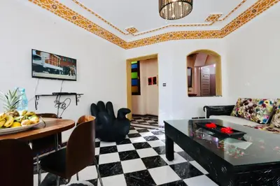 a living room with a couch and a table at résidence qarya syahia private roof terrasse in Marrakech